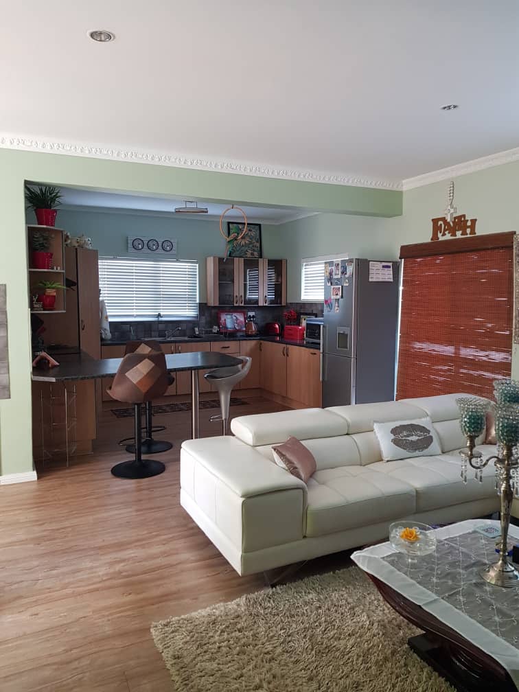 Open plan kitchen - tv area with indoor braai
